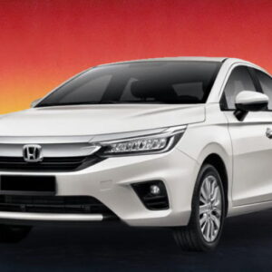 White Honda sedan against a warm evening skyline backdrop.