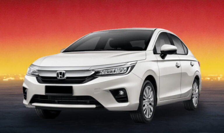 White Honda sedan against a warm evening skyline backdrop.