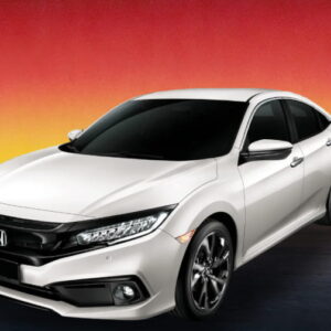 White Honda sedan against a warm evening cityscape background.