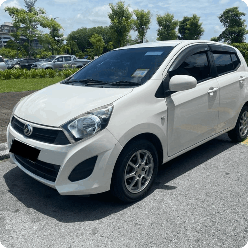 White compact hatchback rental car parked outdoors in a sunny parking lot.
