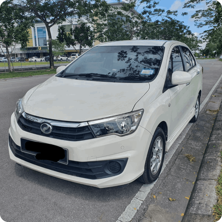 White compact sedan parked on a city roadside under trees.