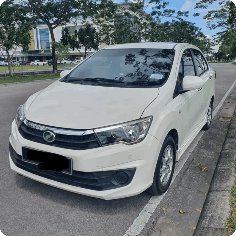 White compact sedan parked on a city roadside under trees.