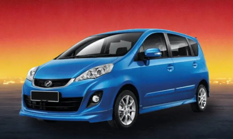 Blue Perodua MPV against a warm evening cityscape background.