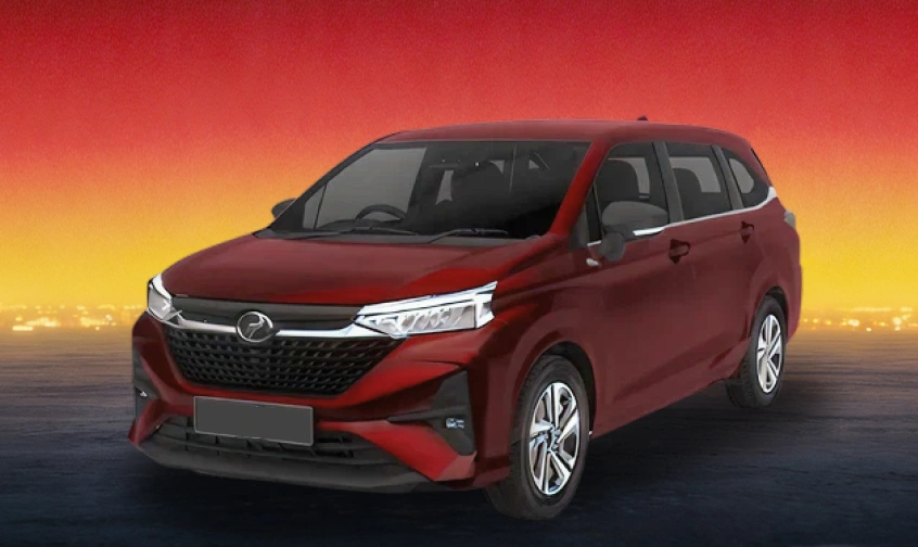 Red Perodua MPV against a warm evening skyline background.