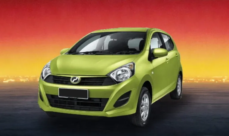 Green Perodua Axia 2016 compact car against a sunset background, budget rental in Kuching
