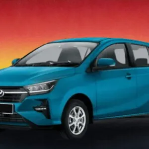Teal Perodua Axia 2023 compact car against a sunset background, available for rental in Kuching