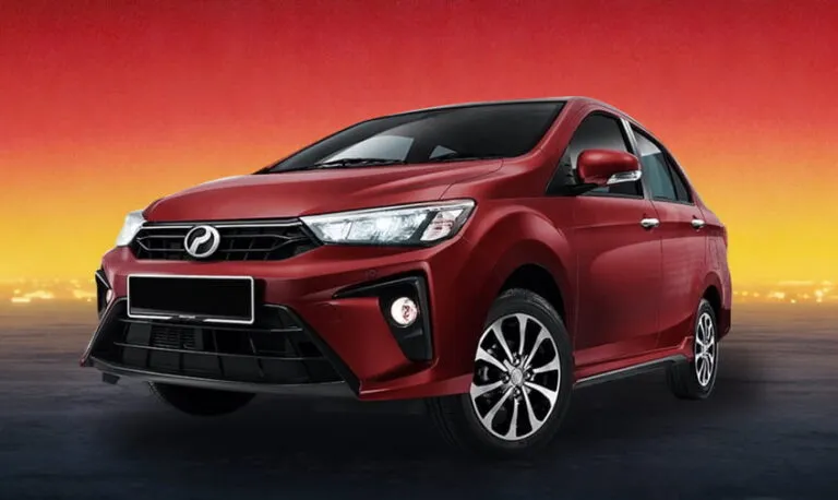 Red compact sedan rental car on a warm twilight gradient backdrop.