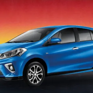 Blue Perodua Myvi 2020 compact car against a sunset background, available for rental in Kuching