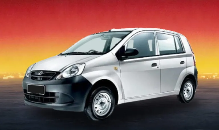 Silver Perodua Viva 2014 compact car against a sunset background, budget rental in Kuching.