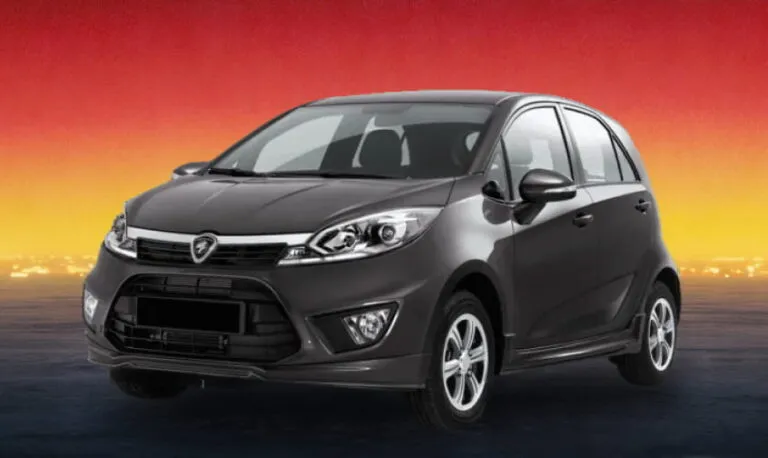 Dark gray Proton Iriz 2016 hatchback against a sunset backdrop, available for rental in Kuching