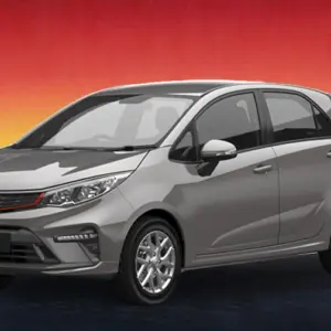 Gray Proton Iriz 2021 hatchback against a sunset city backdrop, available for rental in Kuching
