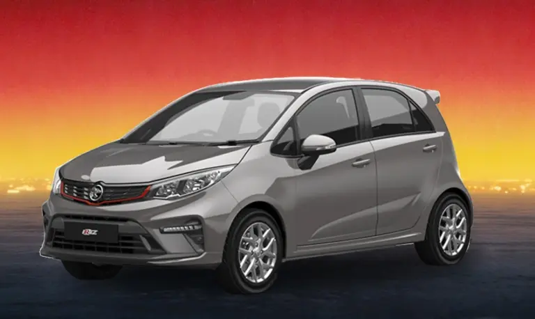Gray compact hatchback rental car on a warm sunset city backdrop.