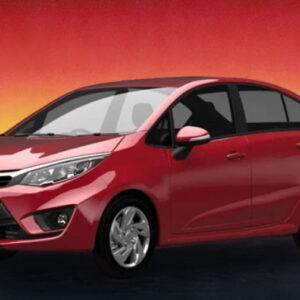 Red compact sedan car on a dark road with a red and yellow sunset sky.