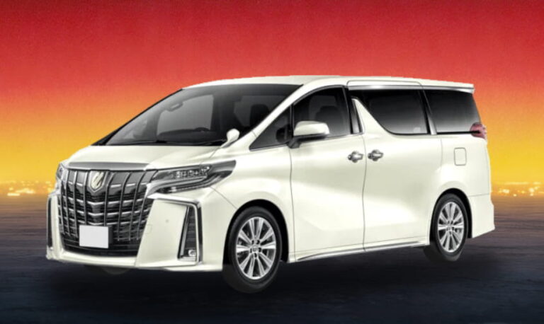 White Toyota luxury MPV against a bright golden-hour backdrop.