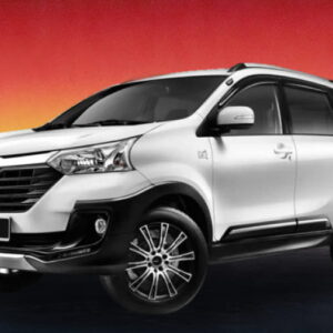 White Toyota MPV against a warm evening skyline background.