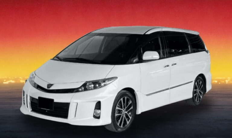 White Toyota MPV against a softly glowing twilight backdrop.