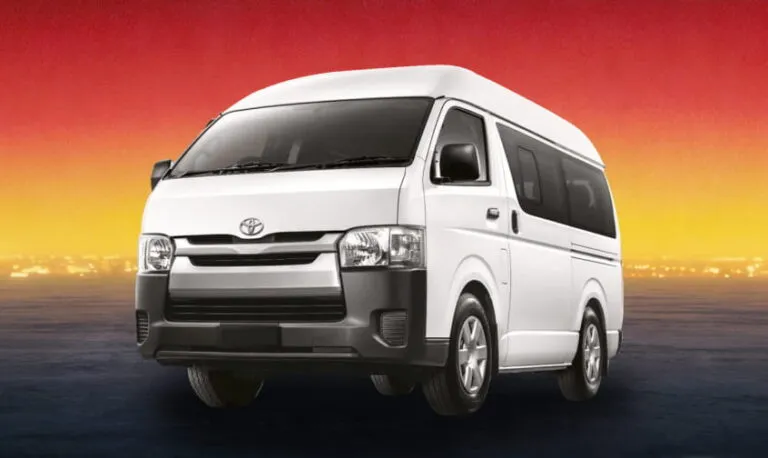 White Toyota Hiace 2016 passenger van at sunset, available for group rental in Kuching