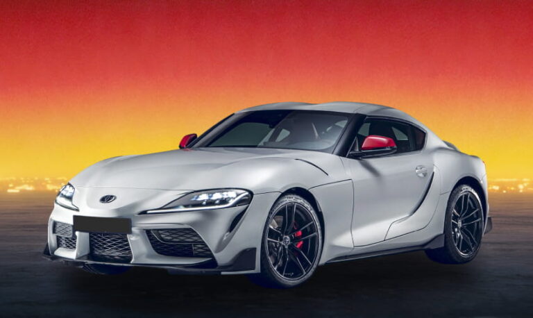 Silver Toyota Supra against a sunset background.