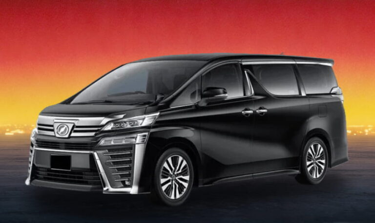 Black Toyota MPV against a deep amber twilight backdrop.
