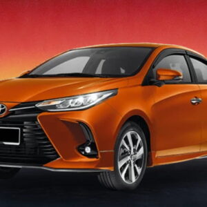 Orange Toyota sedan against a red and yellow sunset background.